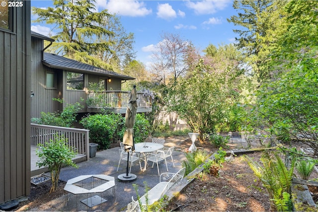 view of patio / terrace featuring outdoor dining space and a deck