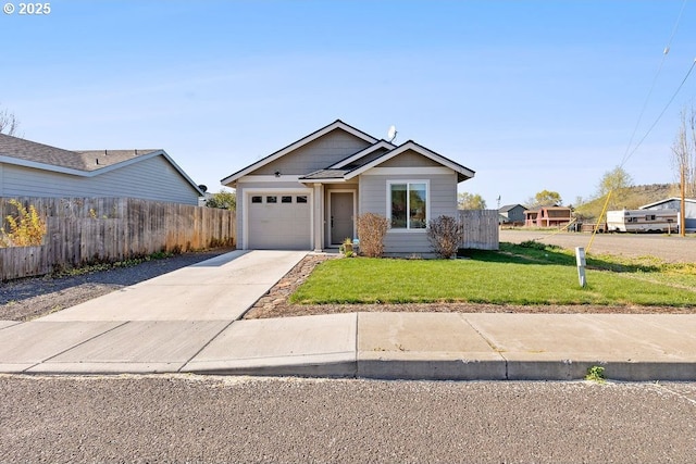 902 SE 3rd St, Prineville, OR 97754 - view of front of house with a front lawn, driveway, a garage, and fence