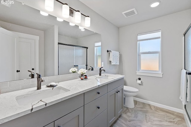 902 SE 3rd St, Prineville, OR 97754 - bathroom featuring a stall shower, visible vents, a sink, and baseboards