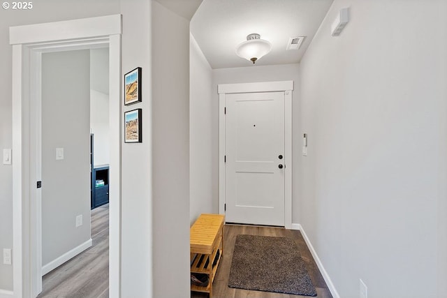 902 SE 3rd St, Prineville, OR 97754 - doorway to outside with wood finished floors, visible vents, and baseboards