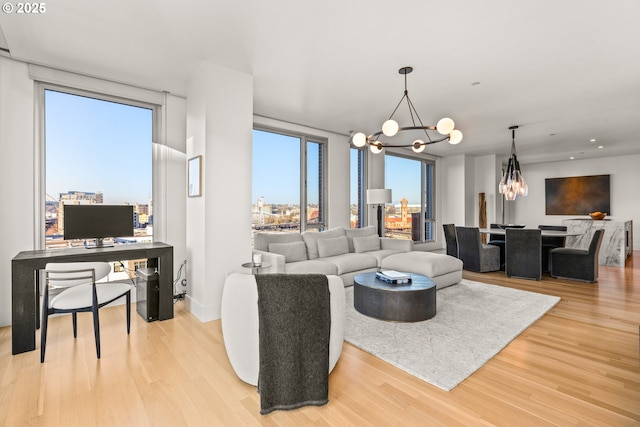 living room featuring a chandelier and light hardwood / wood-style floors