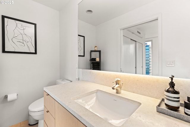 bathroom with vanity and toilet