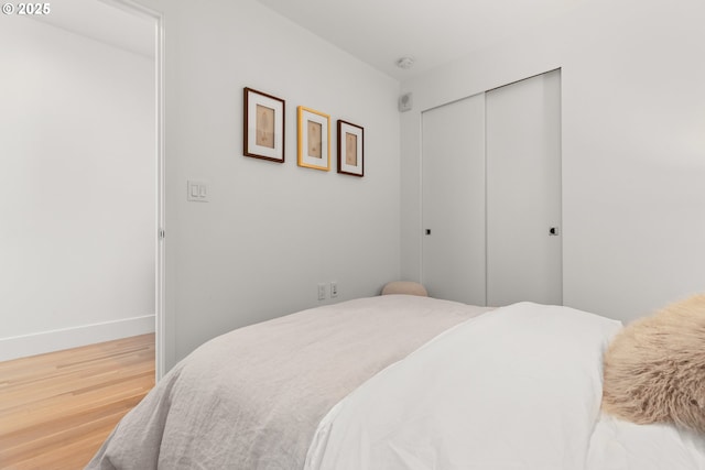 bedroom with hardwood / wood-style flooring and a closet