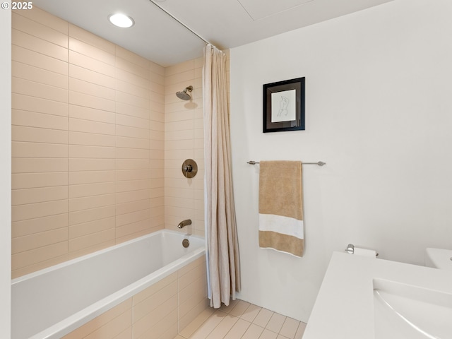 bathroom featuring shower / bath combination with curtain, tile patterned floors, and sink