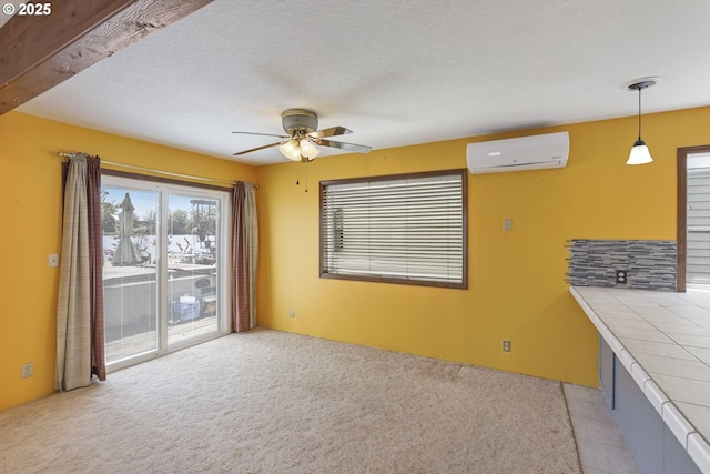 26400 NW St Helens Rd Unit 57, Scappoose, OR 97056 - unfurnished living room with an AC wall unit, a ceiling fan, and light colored carpet