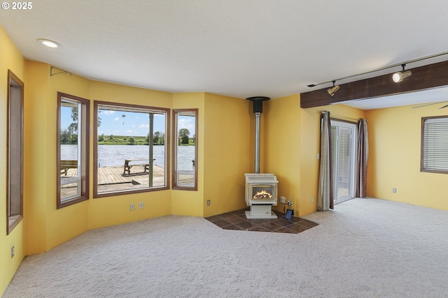 26400 NW St Helens Rd Unit 57, Scappoose, OR 97056 - unfurnished living room featuring carpet, plenty of natural light, and track lighting