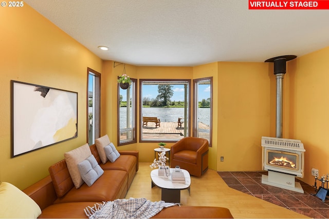 26400 NW St Helens Rd Unit 57, Scappoose, OR 97056 - living area with a water view, a wood stove, and recessed lighting