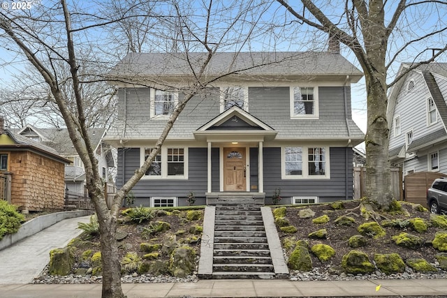 view of front of home featuring fence and a chimney