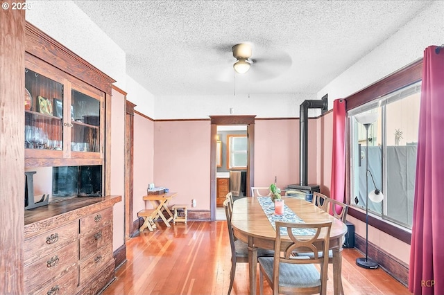 8014 N Johnswood Dr, Portland, OR 97203 - dining room featuring hardwood / wood-style floors, ceiling fan, a textured ceiling, and plenty of natural light