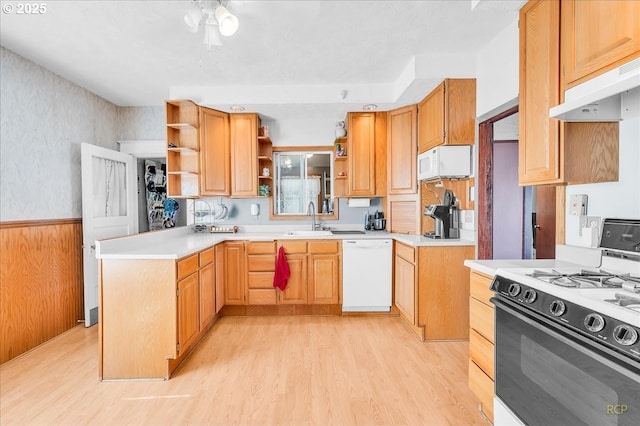 8014 N Johnswood Dr, Portland, OR 97203 - kitchen featuring white appliances, under cabinet range hood, open shelves, light wood-style floors, and wainscoting