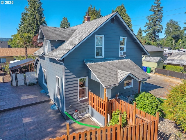 8014 N Johnswood Dr, Portland, OR 97203 - back of property with roof with shingles and a chimney