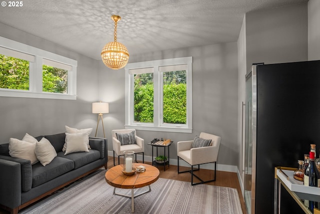 4720 Firwood Rd, Lake Oswego, OR 97035 - living room featuring a chandelier, plenty of natural light, wood finished floors, and a textured ceiling