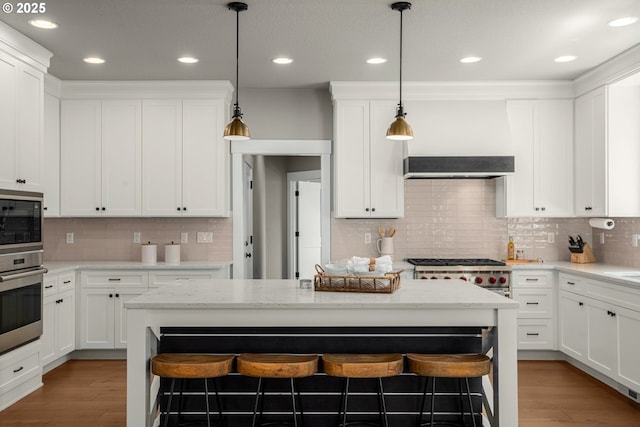 4720 Firwood Rd, Lake Oswego, OR 97035 - kitchen featuring oven, built in microwave, tasteful backsplash, a kitchen bar, and recessed lighting