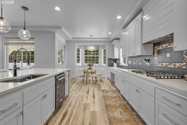 2646 N Lambert St, Cornelius, OR 97113 - kitchen with white gas stovetop, stainless steel dishwasher, recessed lighting, white cabinetry, and light countertops
