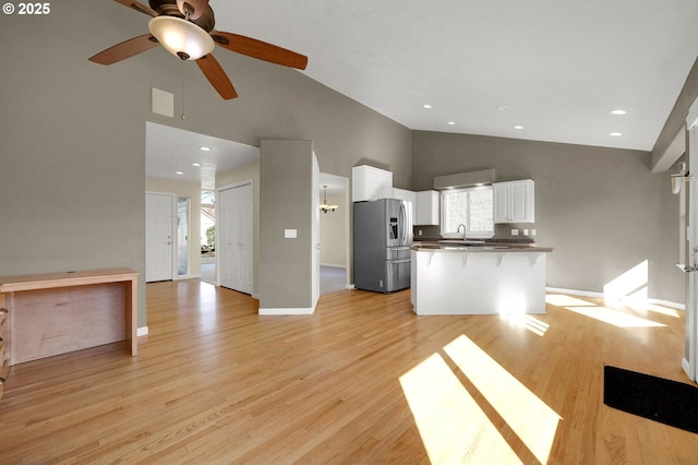 1587 Manchester Dr, Eugene, OR 97401 - kitchen featuring stainless steel fridge with ice dispenser, high vaulted ceiling, open floor plan, white cabinets, and ceiling fan