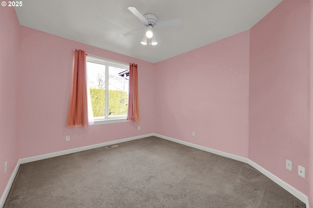 empty room featuring visible vents, ceiling fan, baseboards, and carpet floors