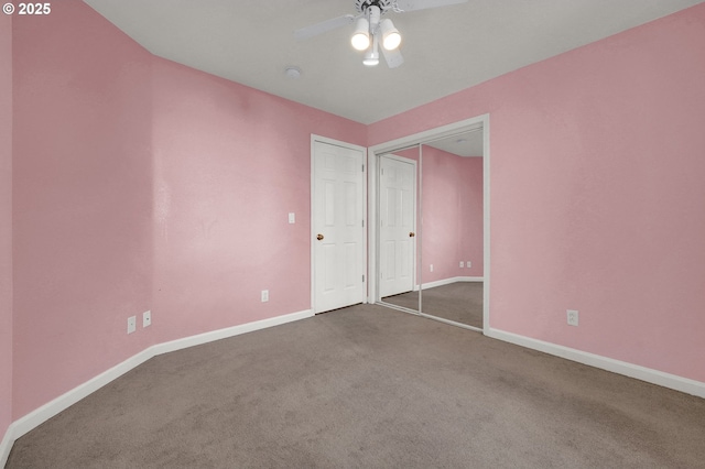 unfurnished bedroom with a closet, baseboards, a ceiling fan, and carpet flooring