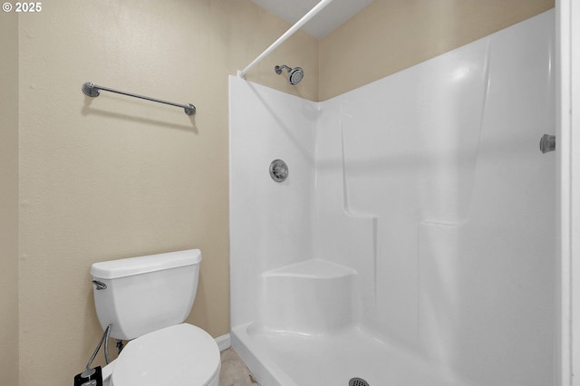 bathroom with toilet and walk in shower
