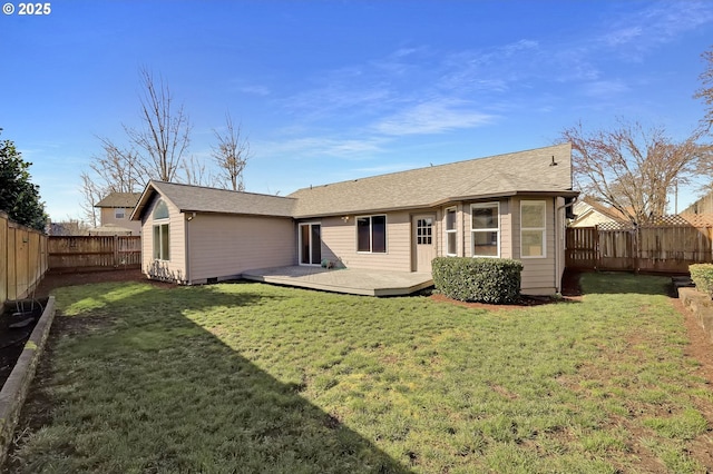 back of property featuring a wooden deck, a lawn, and a fenced backyard
