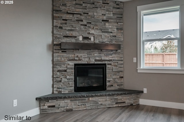 342 NE Cedar St, Sublimity, OR 97385 - detailed view of wood finished floors, baseboards, and a stone fireplace