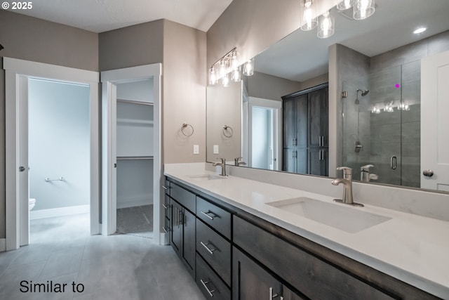 342 NE Cedar St, Sublimity, OR 97385 - full bath with a shower stall, double vanity, toilet, a spacious closet, and baseboards