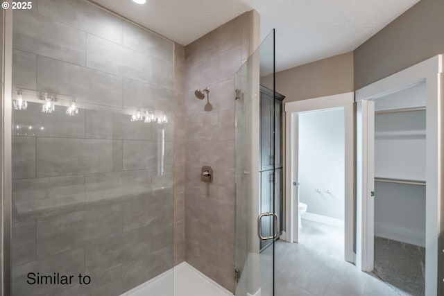 342 NE Cedar St, Sublimity, OR 97385 - bathroom with a shower stall, toilet, a spacious closet, and tile patterned floors