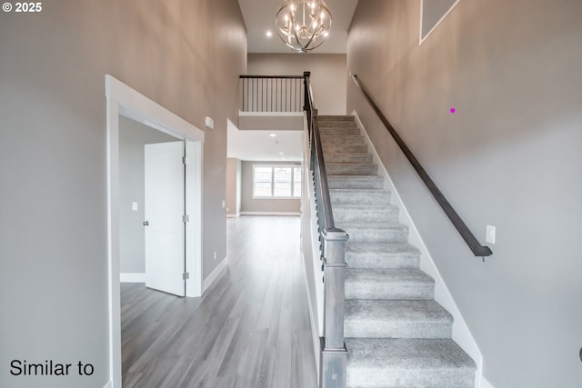 342 NE Cedar St, Sublimity, OR 97385 - staircase with a high ceiling, wood finished floors, baseboards, and a chandelier