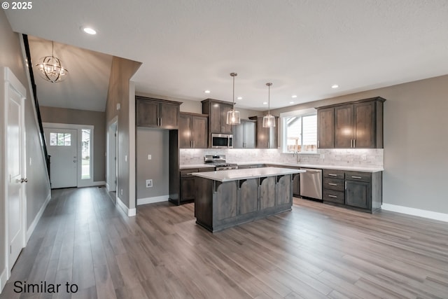 342 NE Cedar St, Sublimity, OR 97385 - kitchen featuring appliances with stainless steel finishes, a chandelier, decorative backsplash, a kitchen island, and recessed lighting
