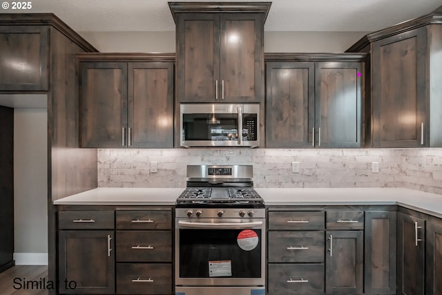 342 NE Cedar St, Sublimity, OR 97385 - kitchen featuring stainless steel appliances, dark brown cabinetry, backsplash, and light countertops