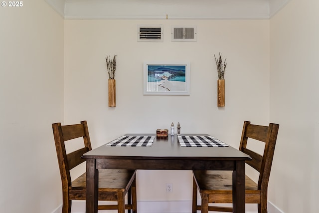 dining room featuring visible vents and baseboards