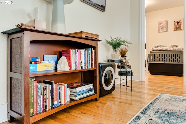 interior space featuring wood finished floors and washer / clothes dryer