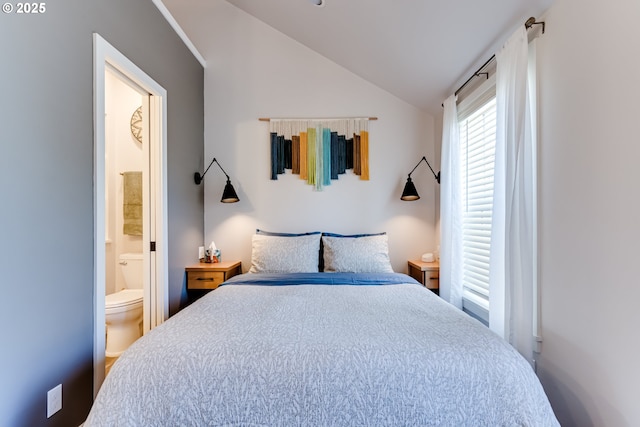 bedroom with ensuite bath and vaulted ceiling