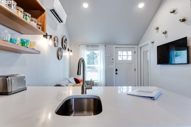 kitchen featuring a wall mounted air conditioner, open shelves, light countertops, vaulted ceiling, and a sink
