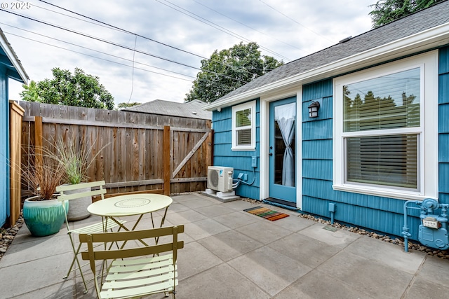 view of patio with fence and ac unit