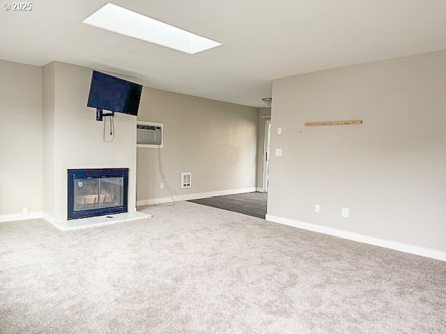 unfurnished living room featuring a wall mounted AC and dark colored carpet