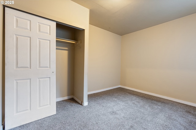 unfurnished bedroom featuring a closet and carpet flooring