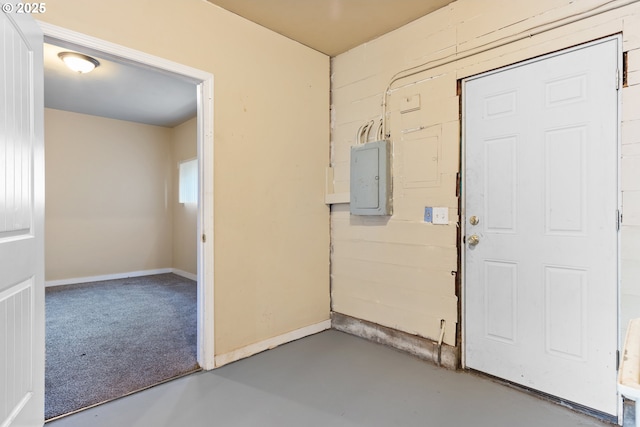 entryway with electric panel and concrete flooring