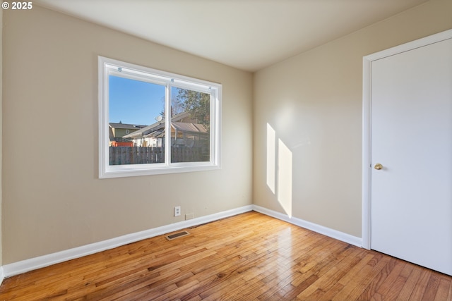 unfurnished room with light wood-type flooring