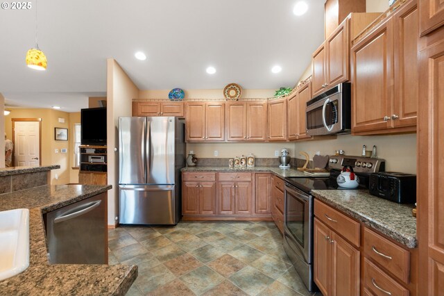 153 Sandwedge Ct, Chehalis, WA 98532 - kitchen with stainless steel appliances, stone finish floors, hanging light fixtures, dark stone counters, and recessed lighting