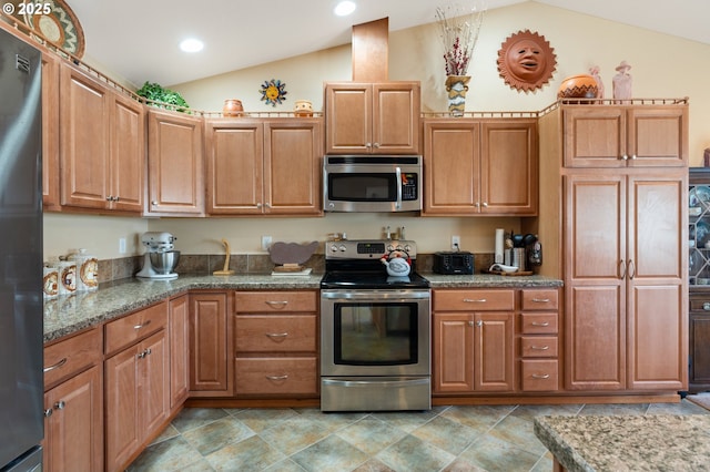 153 Sandwedge Ct, Chehalis, WA 98532 - kitchen with appliances with stainless steel finishes, vaulted ceiling, dark stone countertops, recessed lighting, and brown cabinets