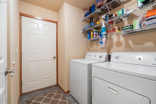 153 Sandwedge Ct, Chehalis, WA 98532 - clothes washing area with washing machine and clothes dryer, baseboards, and stone finish floors