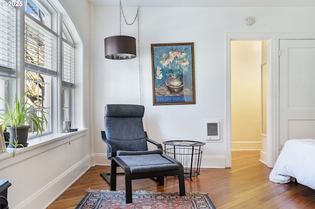 sitting room featuring visible vents, baseboards, and wood finished floors