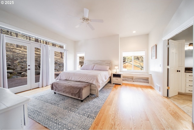 bedroom with ceiling fan, visible vents, access to exterior, french doors, and light wood-type flooring