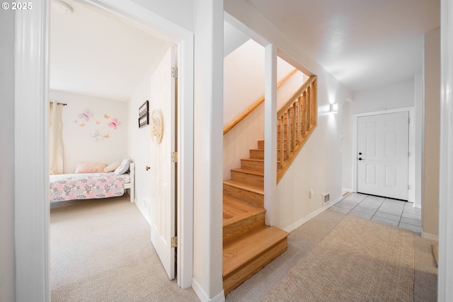 stairway featuring carpet floors and baseboards