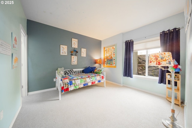 bedroom featuring carpet and baseboards