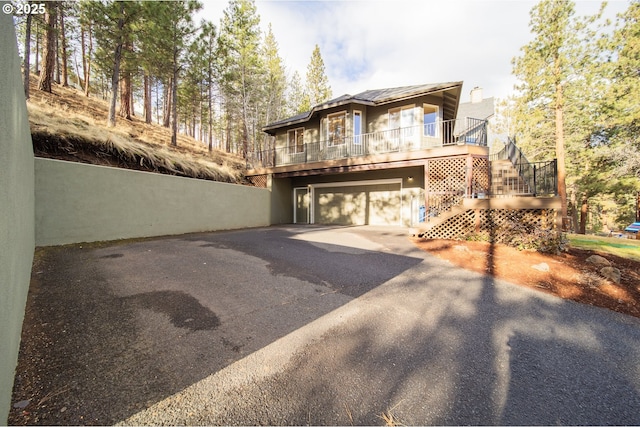 view of front of home featuring driveway, stairway, and an attached garage