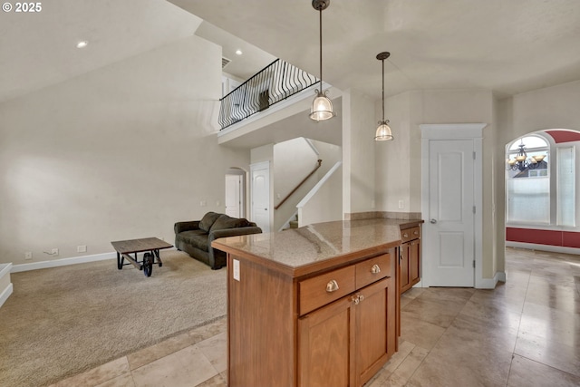3435 Meadow View Dr, Eugene, OR 97408 - kitchen featuring tile counters, light carpet, hanging light fixtures, open floor plan, and brown cabinets