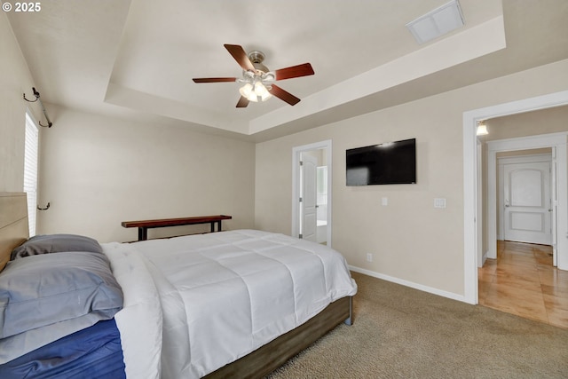 3435 Meadow View Dr, Eugene, OR 97408 - carpeted bedroom with a tray ceiling, baseboards, a ceiling fan, and ensuite bath
