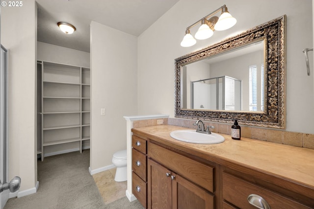 3435 Meadow View Dr, Eugene, OR 97408 - bathroom with a stall shower, vanity, toilet, baseboards, and a spacious closet