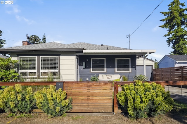 7615 SE 66th Ave, Portland, OR 97206 - bungalow with a fenced front yard, roof with shingles, and a chimney